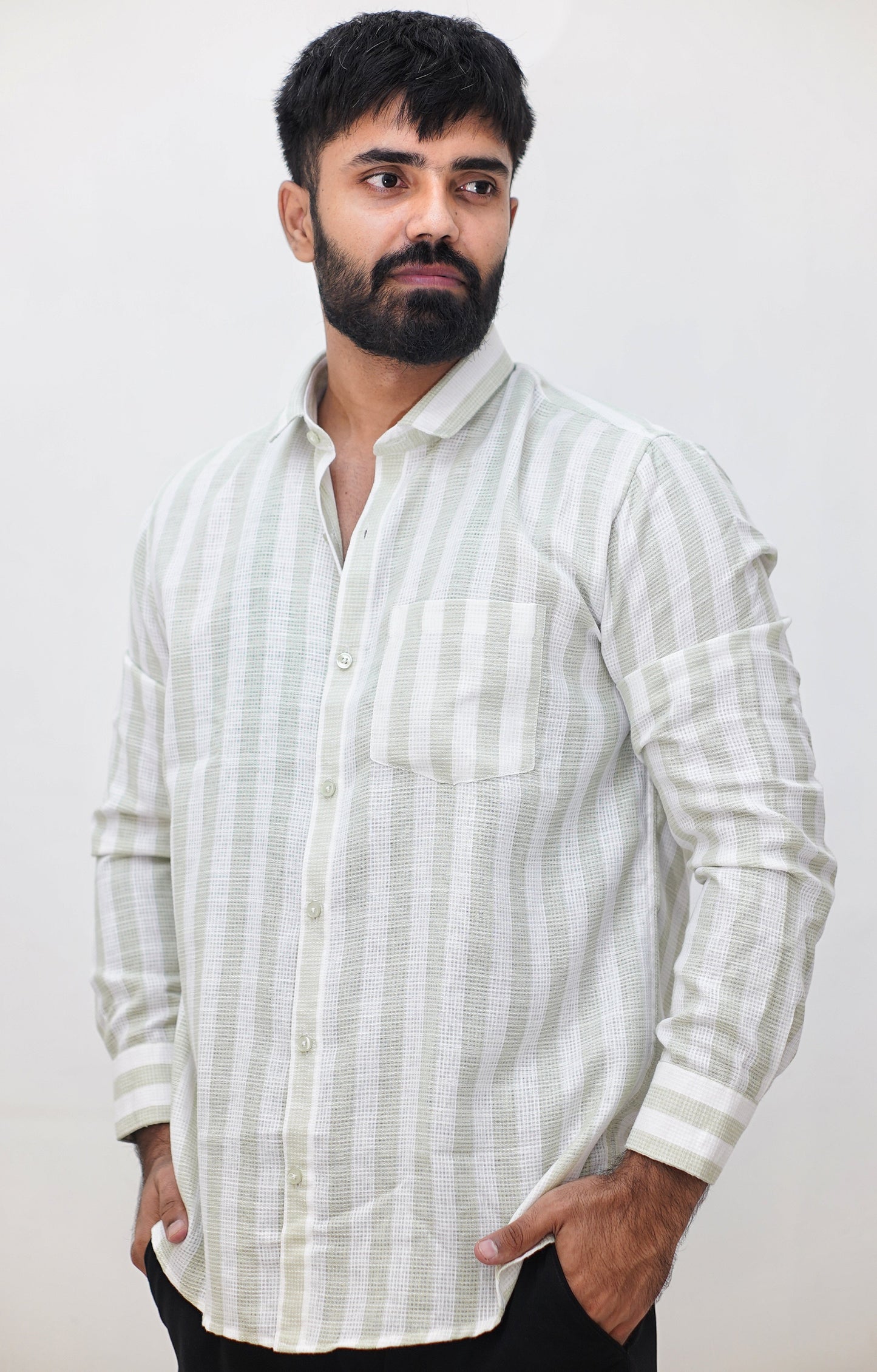 Man wearing a white striped shirt against a plain background